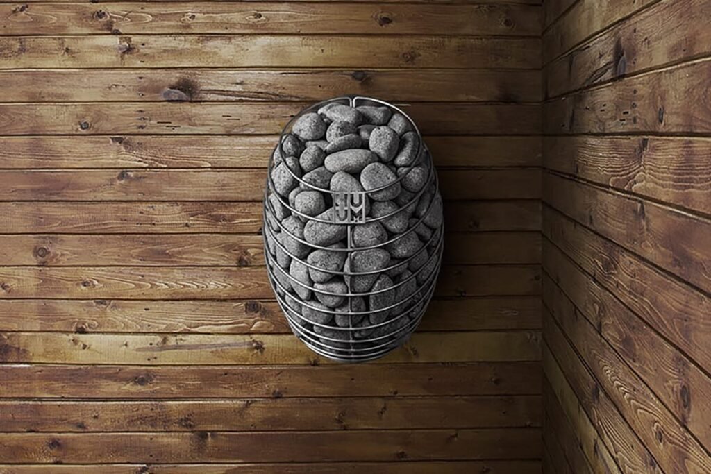 HUUM DROP heater mounted on a dark timber sauna wall
