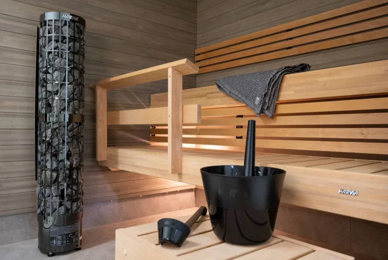 Harvia Cilindro PC66E black steel heater in a timber lined sauna